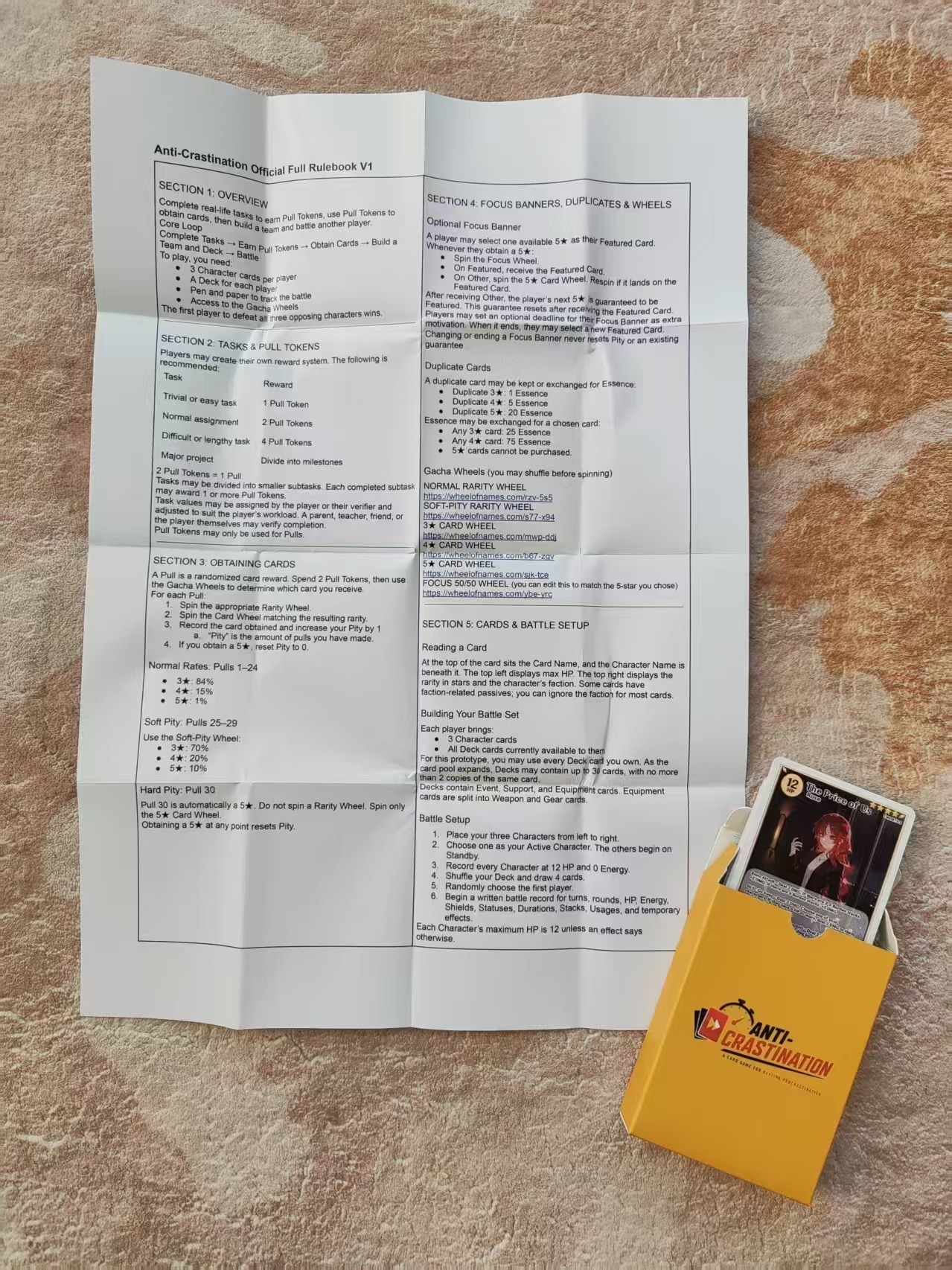 Front side of the folded Anti-Crastination rulebook with deck box